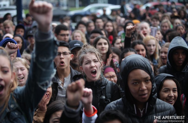 Students raise their fists and chant in solidarity as they gather in front of San Francisco City Hall to protest against gun violence on the one-month anniversary of the high school shooting that a gunman killed 17 people at Marjory Stoneman Douglas High School in Parkland, Florida, Wednesday, March 14, 2018, San Francisco, Calif. (Photo by Ekevara Kitpowsong/Current SF)