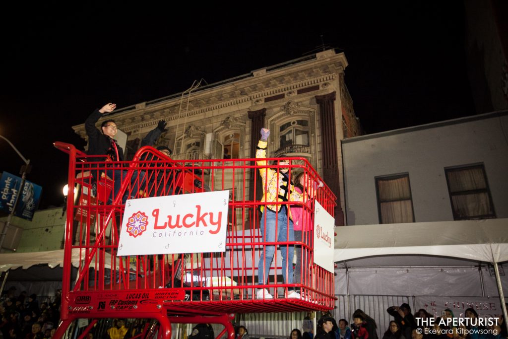 Parade participants from Lucky California in a giant red shopping cart perform in San Francisco's Chinese New Year Parade on Saturday, Feb. 23, 2019. (Photo by Ekevara Kitpowsong/Current SF)