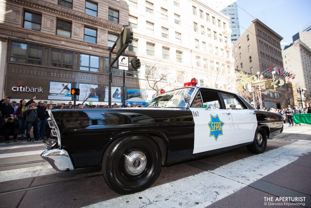 San Francisco police car rolls down Market Street during the 168th annual San Francisco St. Patrick’s Day Parade on Saturday, March 16, 2019. (Photo by Ekevara Kitpowsong/Current SF)