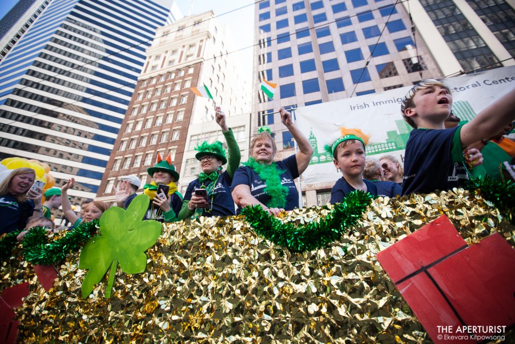 Participants on the float smile and wave to the crowd during the 168th annual San Francisco St. Patrick’s Day Parade on Saturday, March 16, 2019, in San Francisco, Calif. (Photo by Ekevara Kitpowsong/Current SF)
