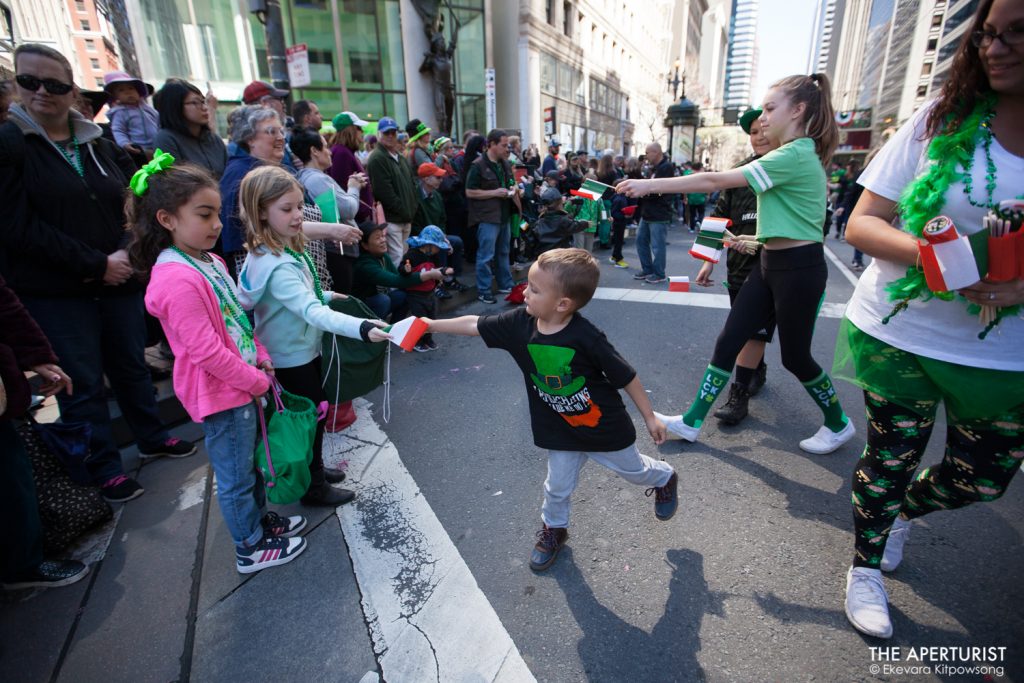 Participants hand out small Irish flags to the parade watchers on Market Street during the 168th annual San Francisco St. Patrick’s Day Parade on Saturday, March 16, 2019, in San Francisco, Calif. (Photo by Ekevara Kitpowsong/Current SF)