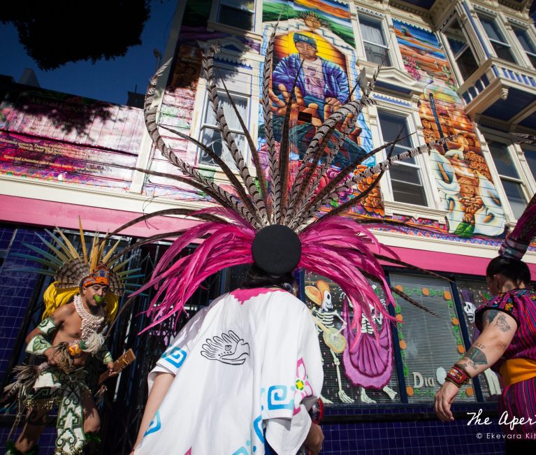 The Danza Xitlalli group performs a blessing ceremony in front of the Justice 4 Amilcar mural on the new offices of the Calle24 Latino Cultural District at 24th and Capp streets in the Mission District, San Francisco on Sunday, Nov. 17, 2019. (Photo by Ekevara Kitpowsong/Current SF)