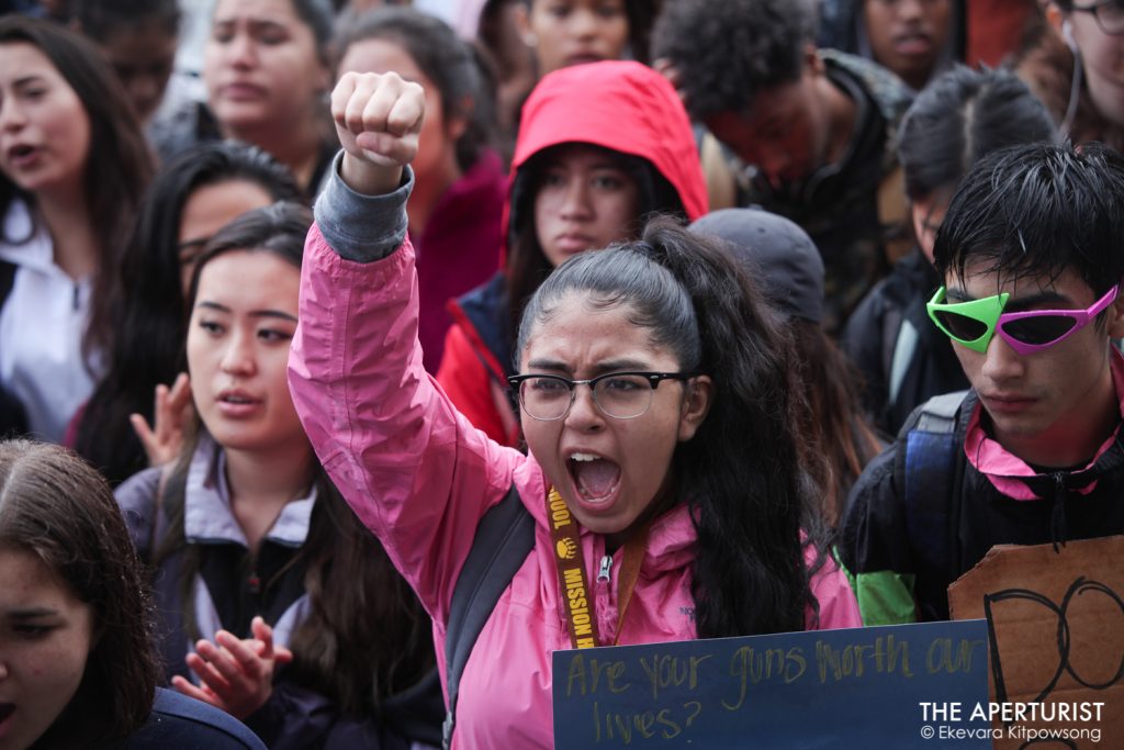 Students raise their fists and chant in solidarity as they gather in front of San Francisco City Hall to protest against gun violence on the one-month anniversary of the high school shooting that a gunman killed 17 people at Marjory Stoneman Douglas High School in Parkland, Florida, Wednesday, March 14, 2018, San Francisco, Calif. (Photo by Ekevara Kitpowsong)