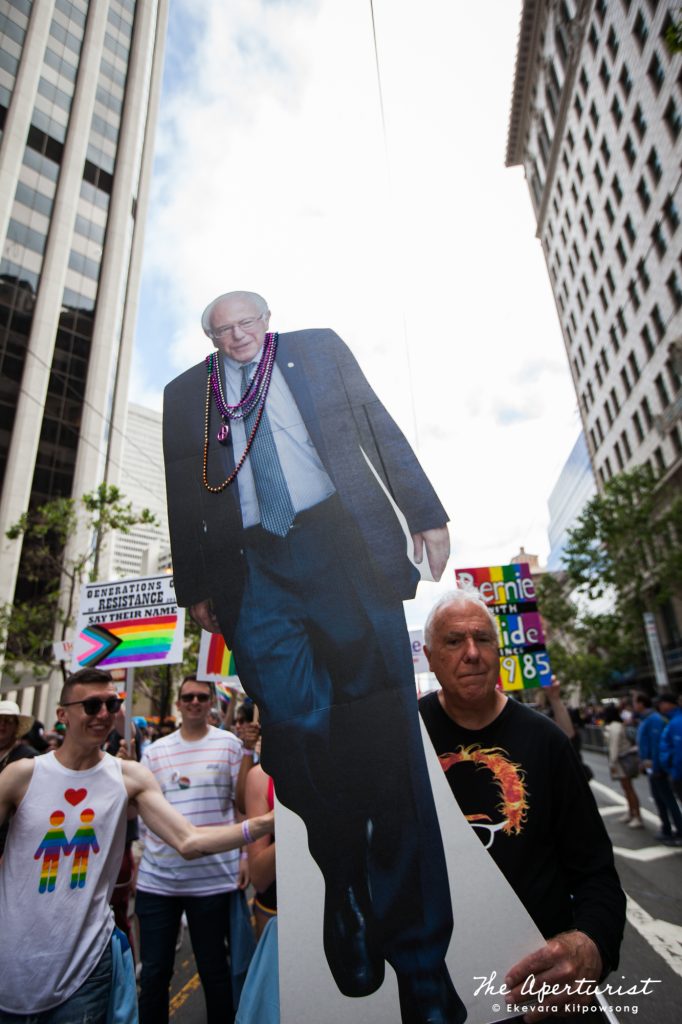 Parade participant holds a large cardboard cutout of U.S. Senator Bernie Sanders of Vermont and a candidate for President of the United States, during the San Francisco Pride Parade on Market Street in San Francisco on June 30, 2019. (Photo by Ekevara Kitpowsong/Current SF) 