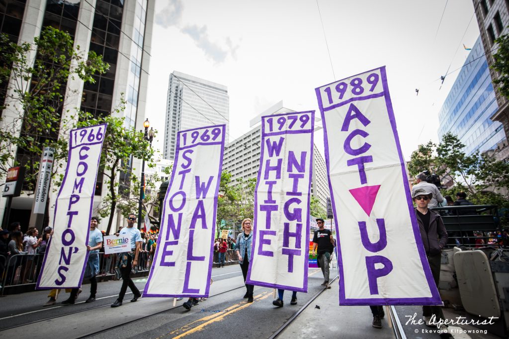 Parade participants hold the Compton’s, Stone Wall, White Night and ACT UP banners as they march along Market Street in San Francisco during the San Francisco Pride Parade on Sunday, June 30, 2019. (Photo by Ekevara Kitpowsong/Current SF)