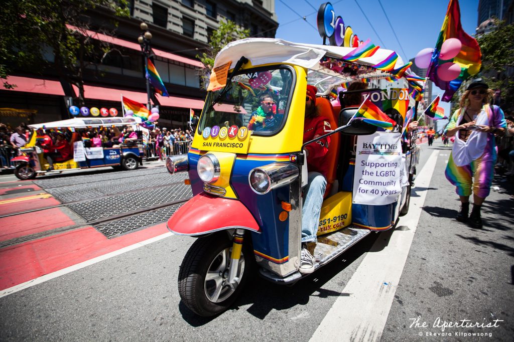 A parade participant from San Francisco Bay Times rides a three-wheeled Tuk Tuk, on Market Street in San Francisco during the San Francisco Pride Parade on Sunday, June 30, 2019. (Photo by Ekevara Kitpowsong/Current SF)